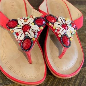 Red and tan sandals with seashells and beads